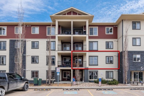 This property features a private balcony with black metal railings, providing outdoor living space - 214 5816 Mullen Place, Edmonton, AB - Outdoor With Balcony With Facade