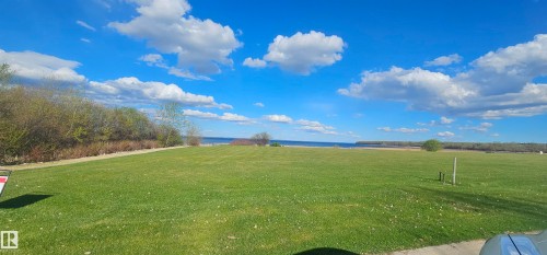 Expansive green lawn with views of the water and horizon - #1 Sunset Harbour, Rural Wetaskiwin County, AB 