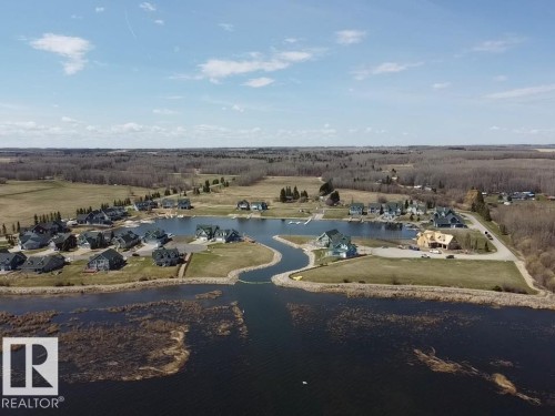 Aerial panorama showcasing a structured residential development with waterfront properties - #1 Sunset Harbour, Rural Wetaskiwin County, AB 