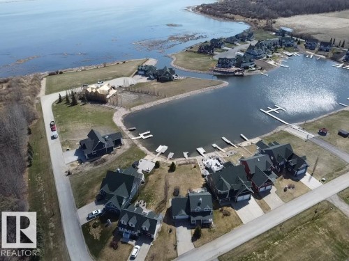 Waterfront community featuring multiple properties with private docks, direct water access, and manicured landscaping - #1 Sunset Harbour, Rural Wetaskiwin County, AB 