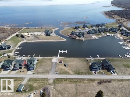 Waterfront community featuring an interior harbor with multiple boat slips, direct lake access, and surrounding residences - #1 Sunset Harbour, Rural Wetaskiwin County, AB 