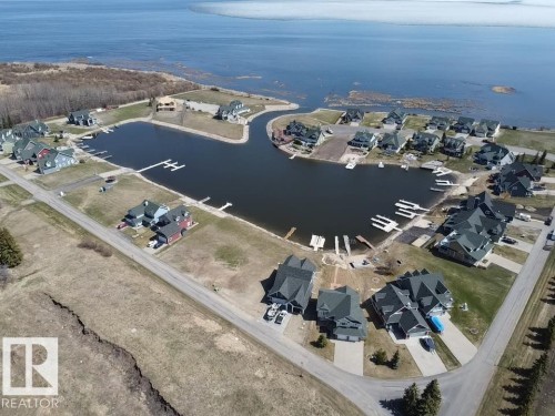 Waterfront community featuring a private harbor with multiple boat docks, direct water access, and a collection of residences with individual driveways - #1 Sunset Harbour, Rural Wetaskiwin County, AB 