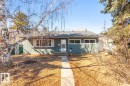 The property features a front yard with a concrete walkway leading to the entrance, mature trees, and a well-maintained exterior with a white front door - 13108 133 Street, Edmonton, AB  - Outdoor 
