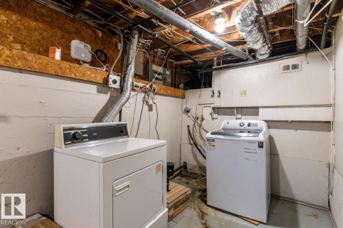 Utility space with concrete walls, exposed ceiling joists, and a washer and dryer - 13108 133 Street, Edmonton, AB - Indoor Photo Showing Laundry Room
