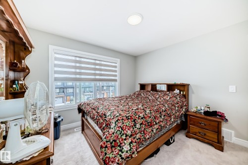 The room features light gray walls and a window with blinds, allowing for adjustable natural light - 7822 Koruluk Link Link, Edmonton, AB - Indoor Photo Showing Bedroom