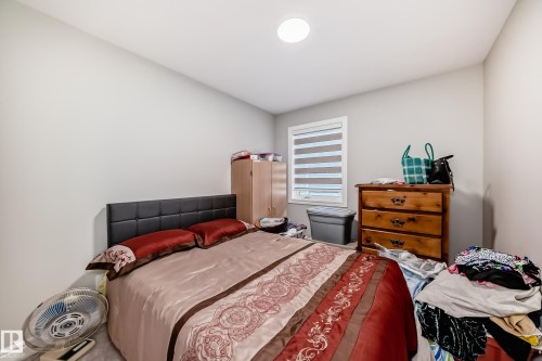 Bedroom featuring light-colored walls and a window with horizontal blinds - 7822 Koruluk Link Link, Edmonton, AB - Indoor Photo Showing Bedroom