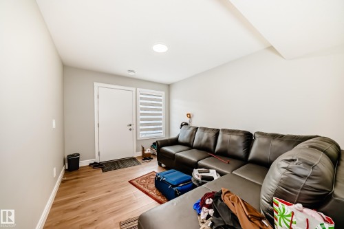 This inviting space features light-toned walls and wood-style flooring, creating a bright atmosphere - 7822 Koruluk Link Link, Edmonton, AB - Indoor Photo Showing Living Room