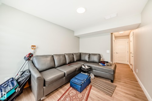 This room features light-colored walls and light-toned flooring, creating a bright and inviting atmosphere - 7822 Koruluk Link Link, Edmonton, AB - Indoor Photo Showing Living Room