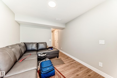 The property features light-colored walls and light wood flooring, with a recessed light fixture in the ceiling - 7822 Koruluk Link Link, Edmonton, AB - Indoor