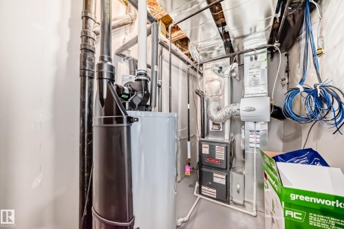 Mechanical room with a water heater and furnace - 7822 Koruluk Link Link, Edmonton, AB - Indoor Photo Showing Basement