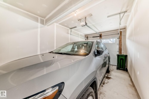 The property includes a single-car garage with an automatic garage door opener and a concrete floor - 7822 Koruluk Link Link, Edmonton, AB - Indoor
