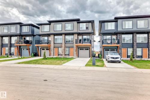 The property features a contemporary exterior with multiple windows and a balcony - 7822 Koruluk Link Link, Edmonton, AB - Outdoor With Facade