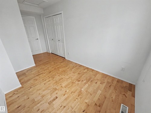 The room features hardwood flooring, white walls, and white trim - #4 Kingbird Road, Rural Bonnyville M.D., AB 