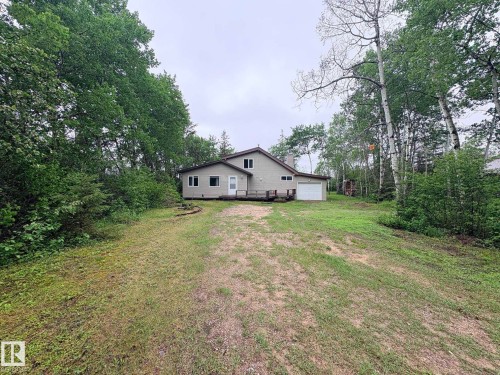 Ranch-style residence featuring neutral-toned siding, a multi-pane window, and a white garage door - #4 Kingbird Road, Rural Bonnyville M.D., AB 