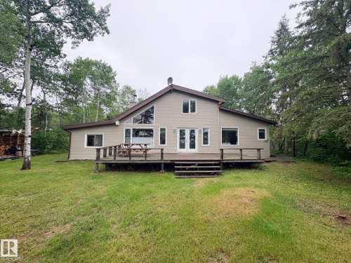 Expansive rear deck featuring wood construction and direct access to the interior - #4 Kingbird Road, Rural Bonnyville M.D., AB 