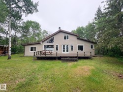 Expansive rear deck featuring wood construction and direct access to the interior - 