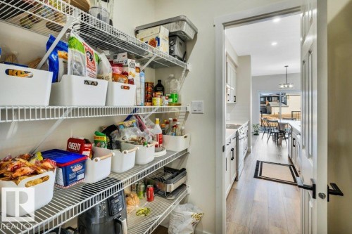 The property features a dedicated pantry with wire shelving, offering extensive storage capacity - 13007 213 Street, Edmonton, AB - Indoor Photo Showing Other Room