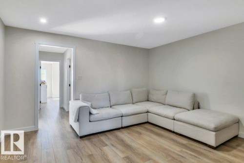 Living area featuring light-colored walls, recessed lighting, and wood-style flooring - 13007 213 Street, Edmonton, AB - Indoor Photo Showing Living Room