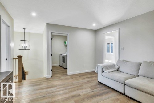 This property features light-toned flooring, recessed lighting, and a neutral color palette throughout - 13007 213 Street, Edmonton, AB - Indoor Photo Showing Living Room