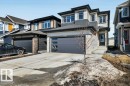 This property features a contemporary exterior with a light-colored siding facade and dark trim - 13007 213 Street, Edmonton, AB  - Outdoor With Facade 