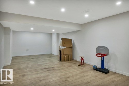 Spacious room featuring light-toned flooring, white walls, and recessed lighting - 13007 213 Street, Edmonton, AB - Indoor
