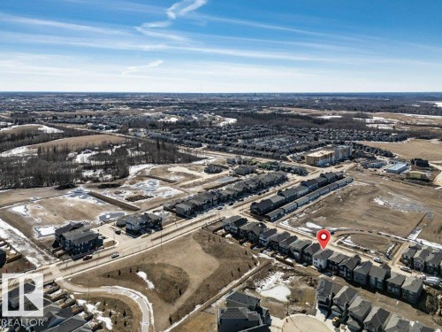 Aerial view of the property and its surrounding area, featuring a residential street with homes and undeveloped land - 13007 213 Street, Edmonton, AB - Outdoor With View