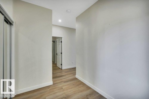 Interior hallway with light-colored walls and wood-look flooring - 13007 213 Street, Edmonton, AB - Indoor Photo Showing Other Room