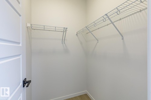 The property features a closet with white wire shelving and light-colored walls - 3828 38 Street E, Beaumont, AB - Indoor With Storage