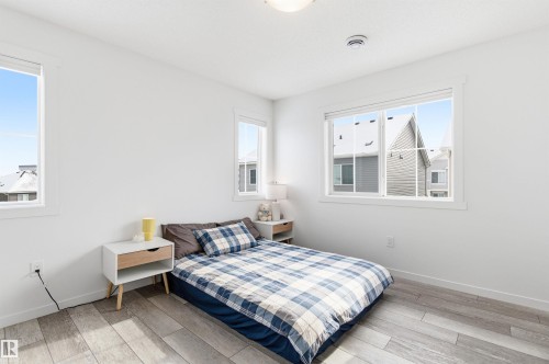 Bedroom with light wood-style flooring and white walls - 58 1110 Daniels Link Link, Edmonton, AB - Indoor Photo Showing Bedroom