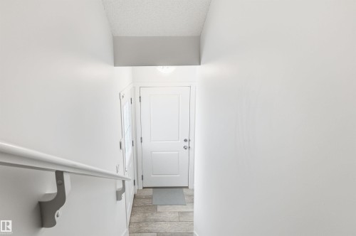 Entryway featuring light-toned walls, a white door, and tiled flooring - 58 1110 Daniels Link Link, Edmonton, AB - Indoor Photo Showing Other Room
