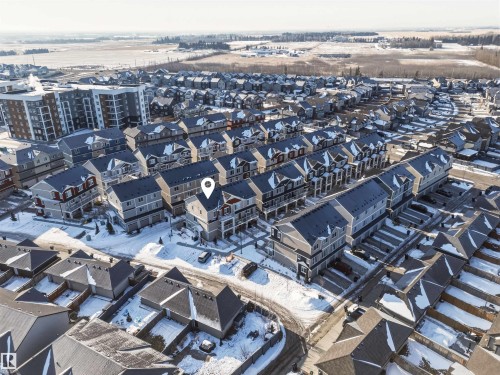 Aerial view highlighting the property within a community featuring residential townhouses and apartment buildings - 58 1110 Daniels Link Link, Edmonton, AB - Outdoor With View