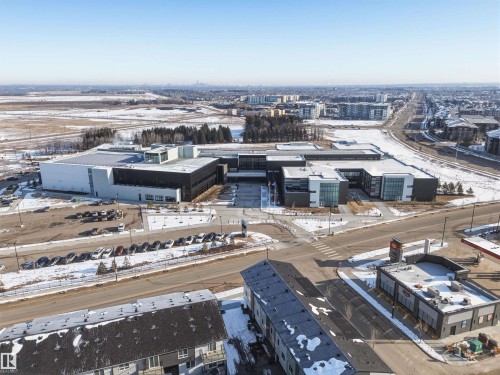 This property features a contemporary architectural style with a flat roof and a mix of dark and light exterior finishes - 58 1110 Daniels Link Link, Edmonton, AB - Outdoor With View