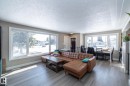 This living space features light gray wood-look flooring and light-colored walls - 12 Mill Drive, St. Albert, AB  - Indoor Photo Showing Living Room 