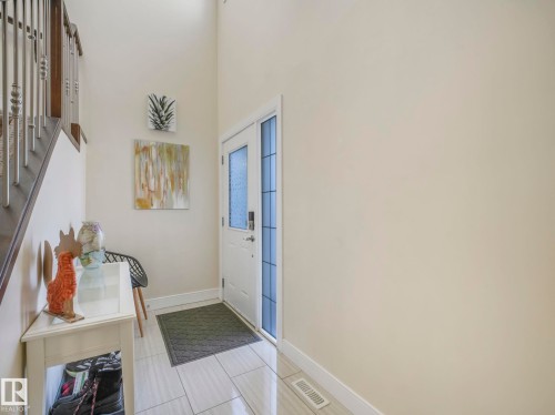 The property features a bright entryway with light-toned walls and tile flooring - 3910 49 Avenue, Beaumont, AB - Indoor Photo Showing Other Room