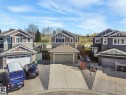 The property features a two-story exterior with light green siding and brown shingle accents - 3910 49 Avenue, Beaumont, AB  - Outdoor With Facade 