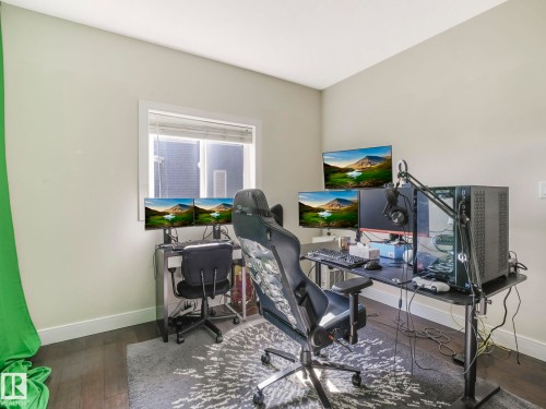 This room features hardwood flooring, light-colored walls, and a window with blinds - 3910 49 Avenue, Beaumont, AB - Indoor Photo Showing Office