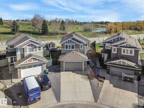 This property features a two-story design with an attached garage, a paved driveway, and a fenced yard - 3910 49 Avenue, Beaumont, AB - Outdoor