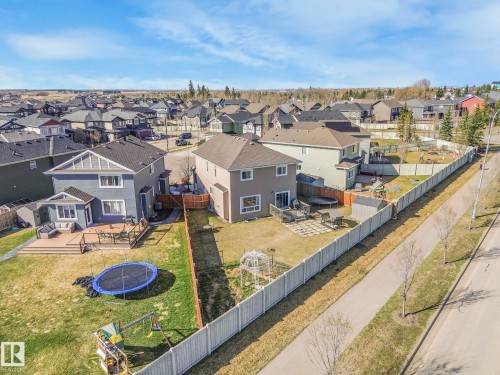 The property features a private yard with a wooden deck and a privacy fence - 3910 49 Avenue, Beaumont, AB - Outdoor