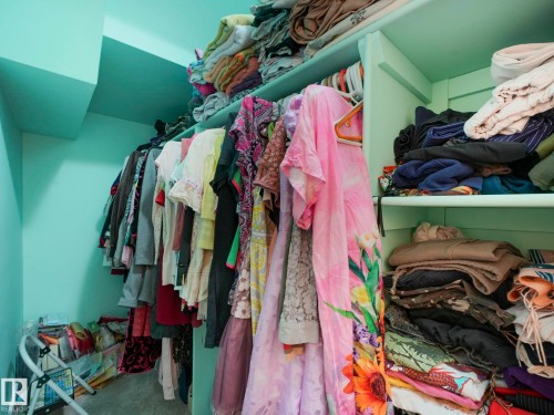 The property includes a walk-in closet with built-in shelving and hanging rods - 3910 49 Avenue, Beaumont, AB - Indoor With Storage