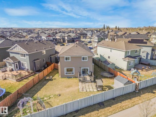 The property features a fenced yard, a wooden deck, and a storage shed - 3910 49 Avenue, Beaumont, AB - Outdoor