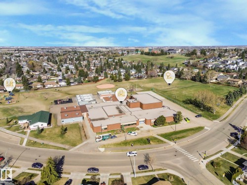 Aerial view showcasing the property's proximity to a sports field, a playground, and other community amenities - 3910 49 Avenue, Beaumont, AB - Outdoor With View