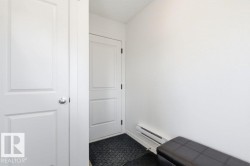 Entryway featuring white doors and a white wall - 
