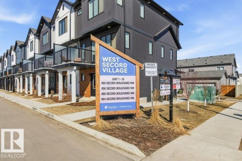 Contemporary townhomes featuring a mix of dark and light-colored siding, private balconies with glass railings, and a clean, modern aesthetic - 49 850 Secord Boulevard, Edmonton, AB - Outdoor