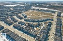 Aerial view of the residential area, featuring an array of homes with dark roofs and surrounding open spaces - 21003 131 Avenue, Edmonton, AB  - Outdoor With View 