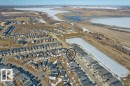 Aerial view showcasing the community's proximity to a body of water and surrounding open terrain - 21003 131 Avenue, Edmonton, AB  - Outdoor With Body Of Water With View 