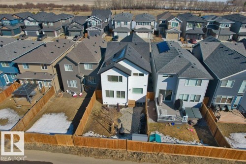 Aerial view showcasing the property's modern exterior, fenced yard, and surrounding residential neighborhood - 21003 131 Avenue, Edmonton, AB - Outdoor