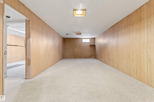 This room features light-toned wood paneling on the walls, a neutral carpet, and recessed lighting - 8608 156 Street, Edmonton, AB - Indoor