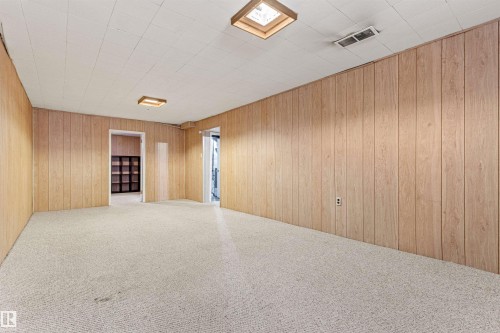 This room features light-toned wood paneling on the walls, a white paneled ceiling, and light-colored carpeting - 8608 156 Street, Edmonton, AB - Indoor Photo Showing Other Room
