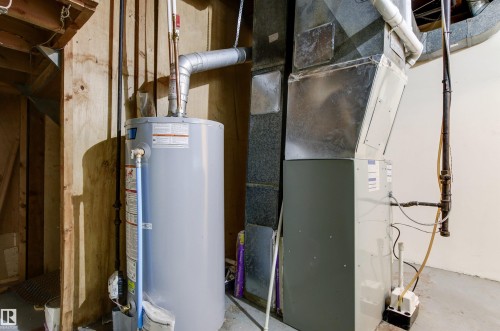 The property includes a water heater and furnace, providing essential utilities - 8608 156 Street, Edmonton, AB - Indoor Photo Showing Basement
