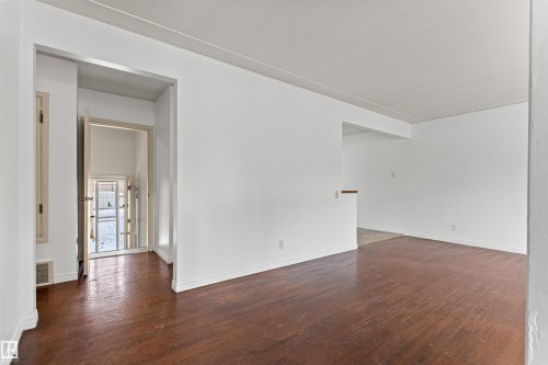 This interior space features dark wood floors and white walls - 8608 156 Street, Edmonton, AB - Indoor Photo Showing Other Room